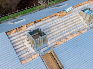 An aerial view of a metal roof being built.