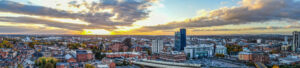 The sun is setting over the city of birmingham, england.